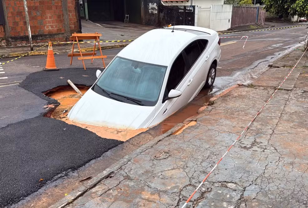 Carro afunda em cratera após chuva de 100 mm em Campo Grande